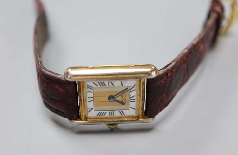 A ladys 925 gilt Cartier Vermeil Tank quartz rectangular wrist watch, with three colour Roman dial, on Cartier leather strap,